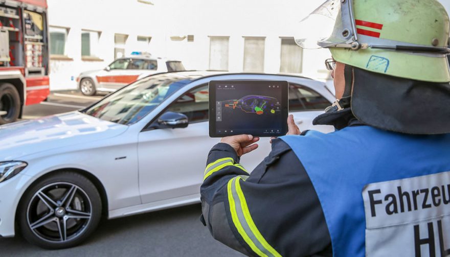 A firefighter demonstrates the new Merecedes safety app