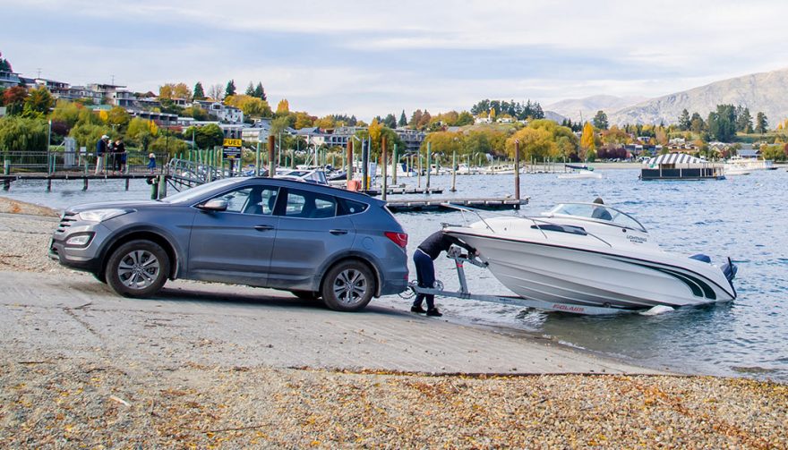 After towing a boat, a car backs the vessel into the water. Don't damage from towing a boat with a car.