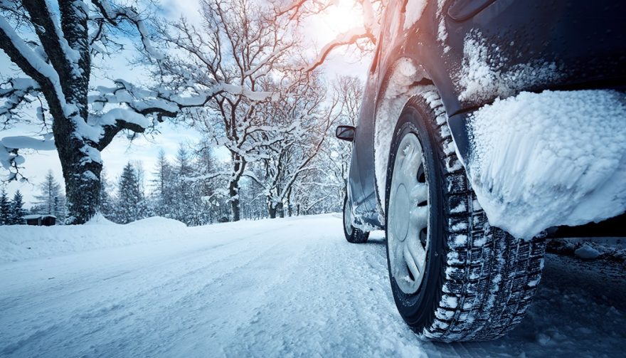 Car driving on snow shows why it is important to winterize your car