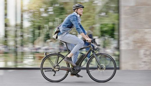 How do electric bikes work A man riding on an electric bike.